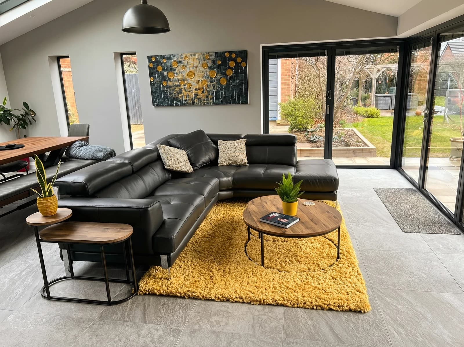 The living room area of the completed extension with bifold doors and garden view