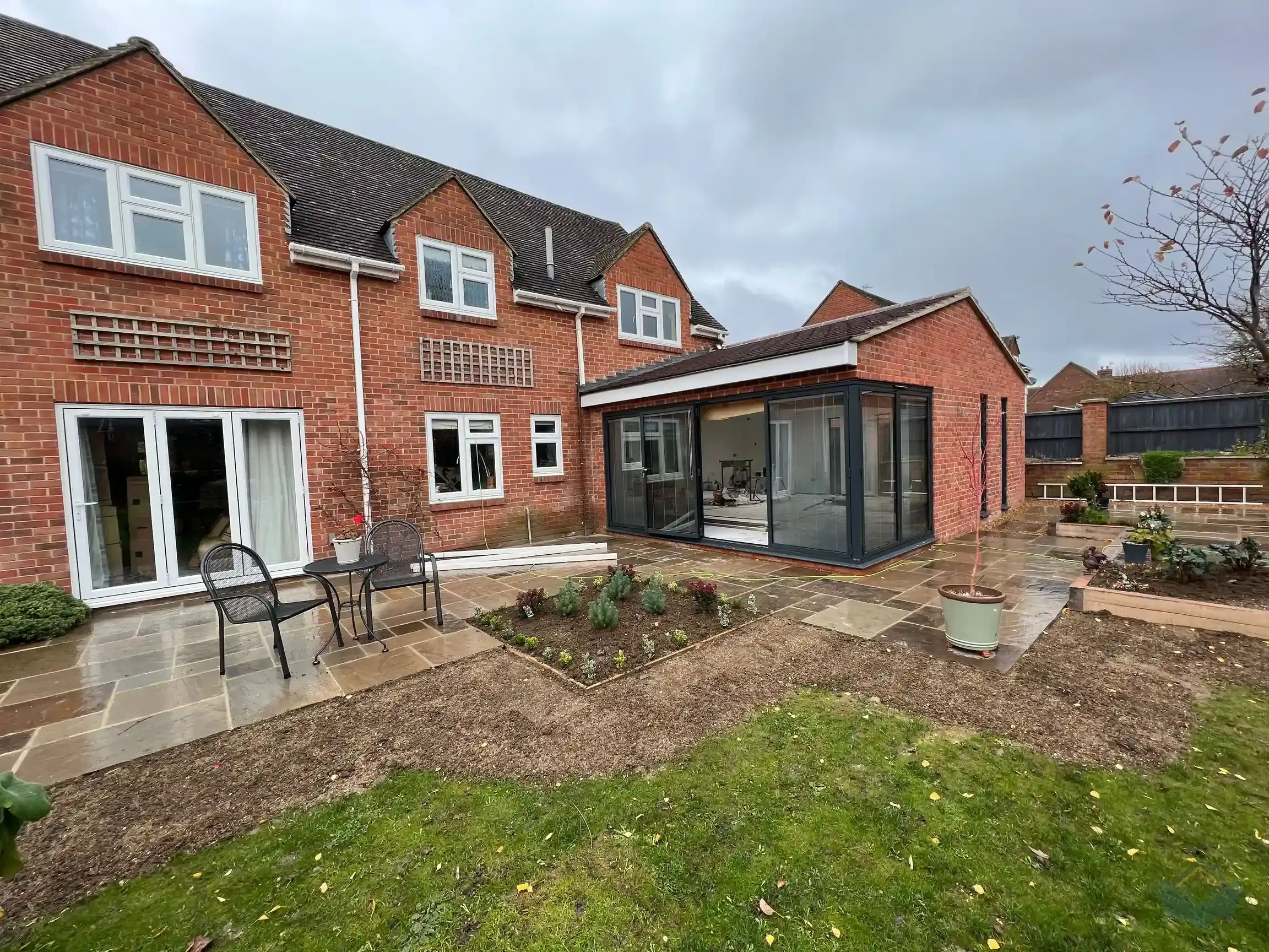 The finished rear of the extension in early December 2022, with the completed patio and newly planted flowerbeds in front of the new bifold doors, and the gutters not yet fitted.